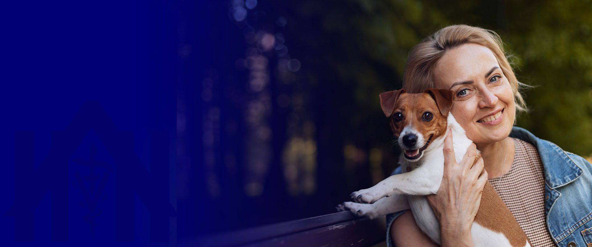 smiley woman holding dog